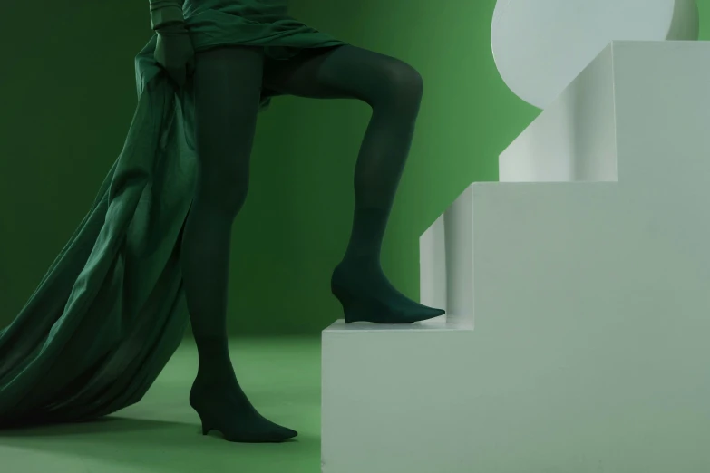 a woman in a green dress and black tights, shot with sony alpha, silk shoes, innovation, rectangle