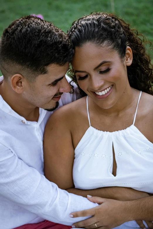 a man and a woman sitting next to each other, inspired by Gina Pellón, pexels contest winner, arm around her neck, latina, wearing white cloths, third trimester