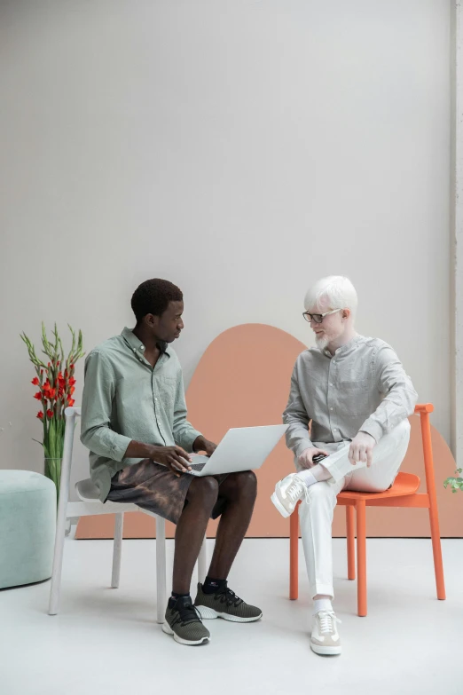 a man sitting next to a woman on a laptop, by Jakob Emanuel Handmann, trending on unsplash, aestheticism, orange pastel colors, sitting in a waiting room, non-binary, off - white collection