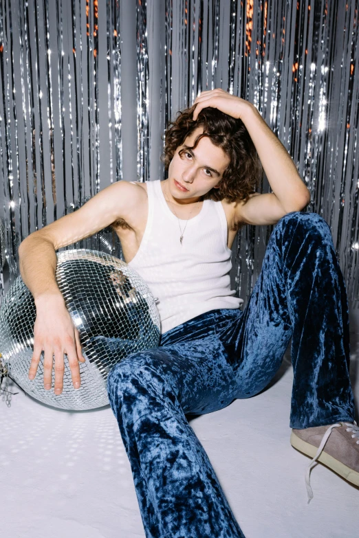 a man sitting in front of a disco ball, portrait of timothee chalamet, taken in the mid 2000s, kailee mandel, 90's color photo