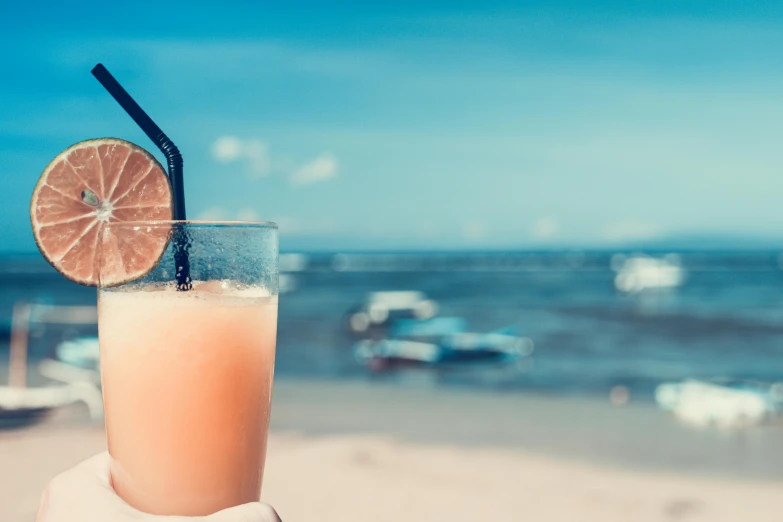 a person holding a glass of orange juice on the beach, pexels contest winner, renaissance, lounge background, titled'holiday at the beach ', interesting background, thumbnail