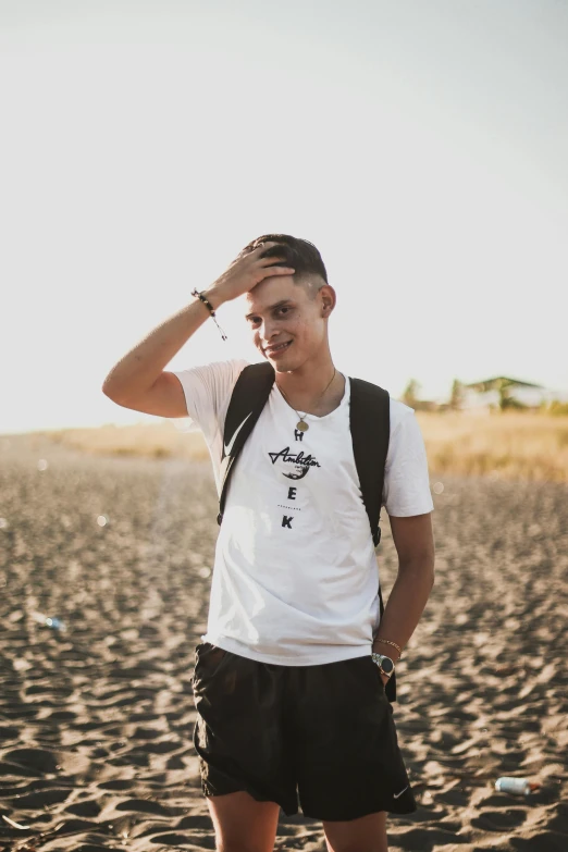 a man standing on top of a sandy beach, discord profile picture, white and black clothing, around 20 yo, style of anton fadeev