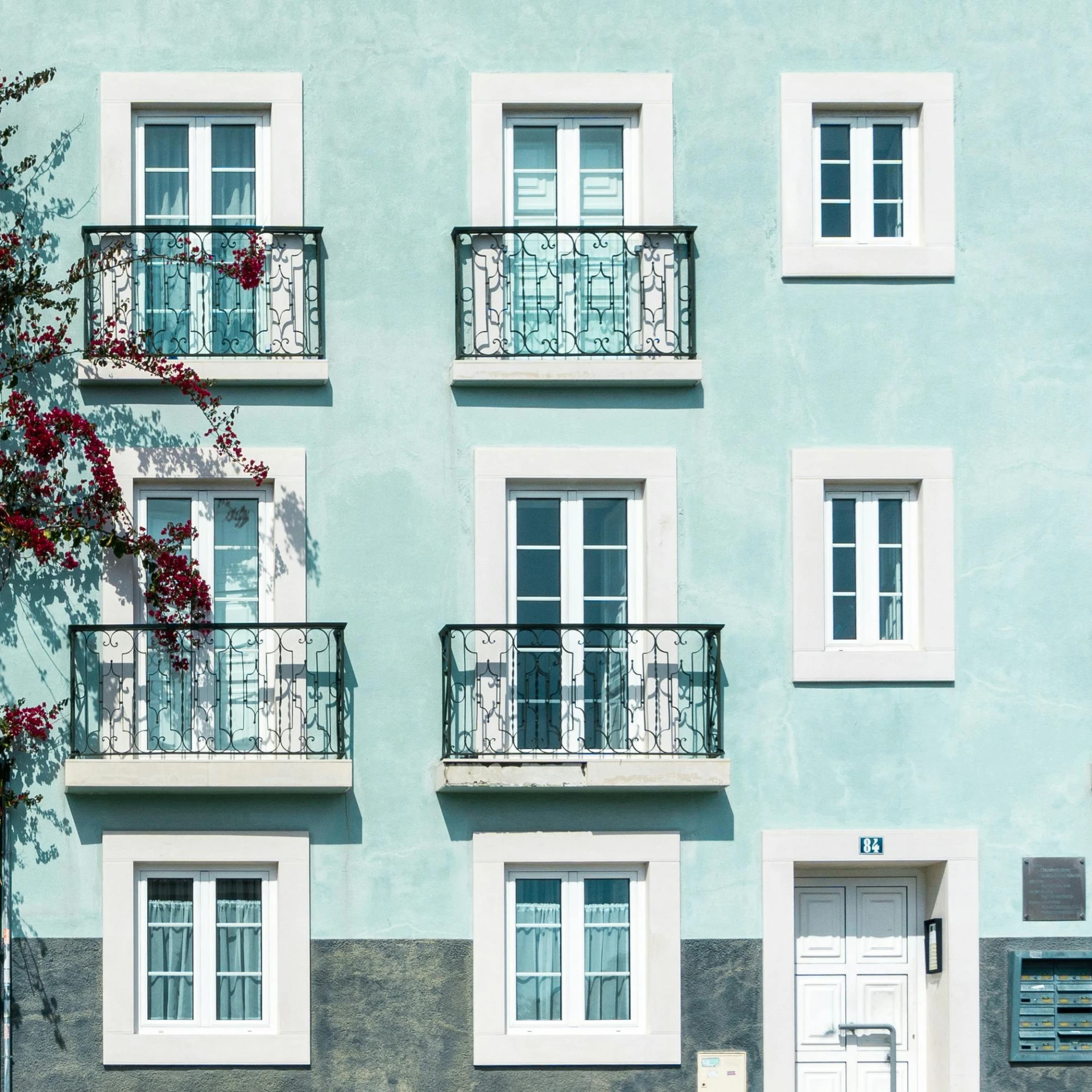 a blue building with white windows and balconies, pexels contest winner, neoclassicism, portugal, white and teal metallic accents, black windows, pastel green