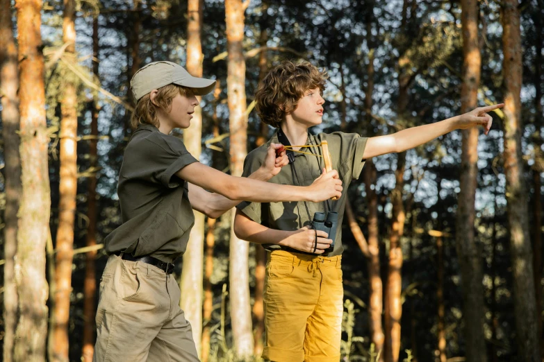 a couple of men standing next to each other in a forest, by Dietmar Damerau, pexels, renaissance, boy scout troop, kids playing, tan, thumbnail