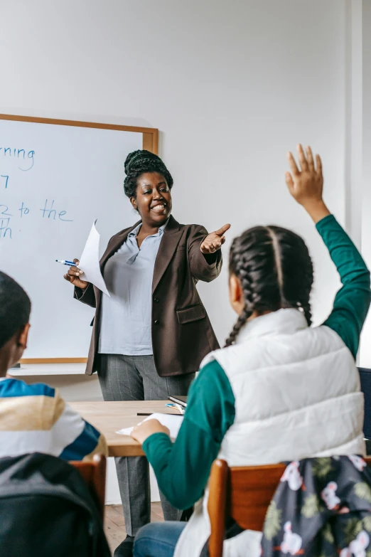 a teacher teaching a group of children in a classroom, pexels contest winner, american barbizon school, photo of a black woman, pointing, on a canva, high-quality photo