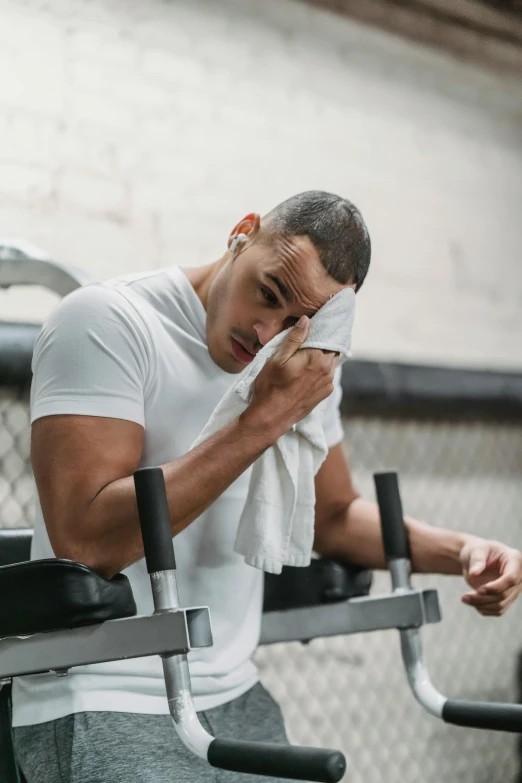 a man wiping his face in a gym, pexels contest winner, renaissance, crying engine, low quality photo, cooling, promo image