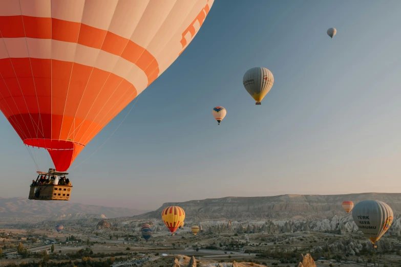 a group of hot air balloons flying over a valley, pexels contest winner, wes anderson film, cyprus, rocket launching into the sky, istanbul