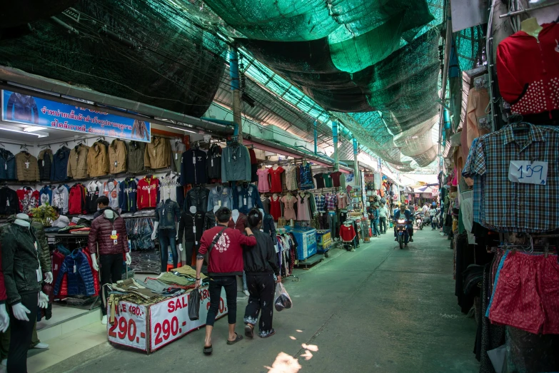 a group of people walking through a market, unsplash, hurufiyya, futuristic phnom-penh cambodia, thumbnail, garments, hidden area