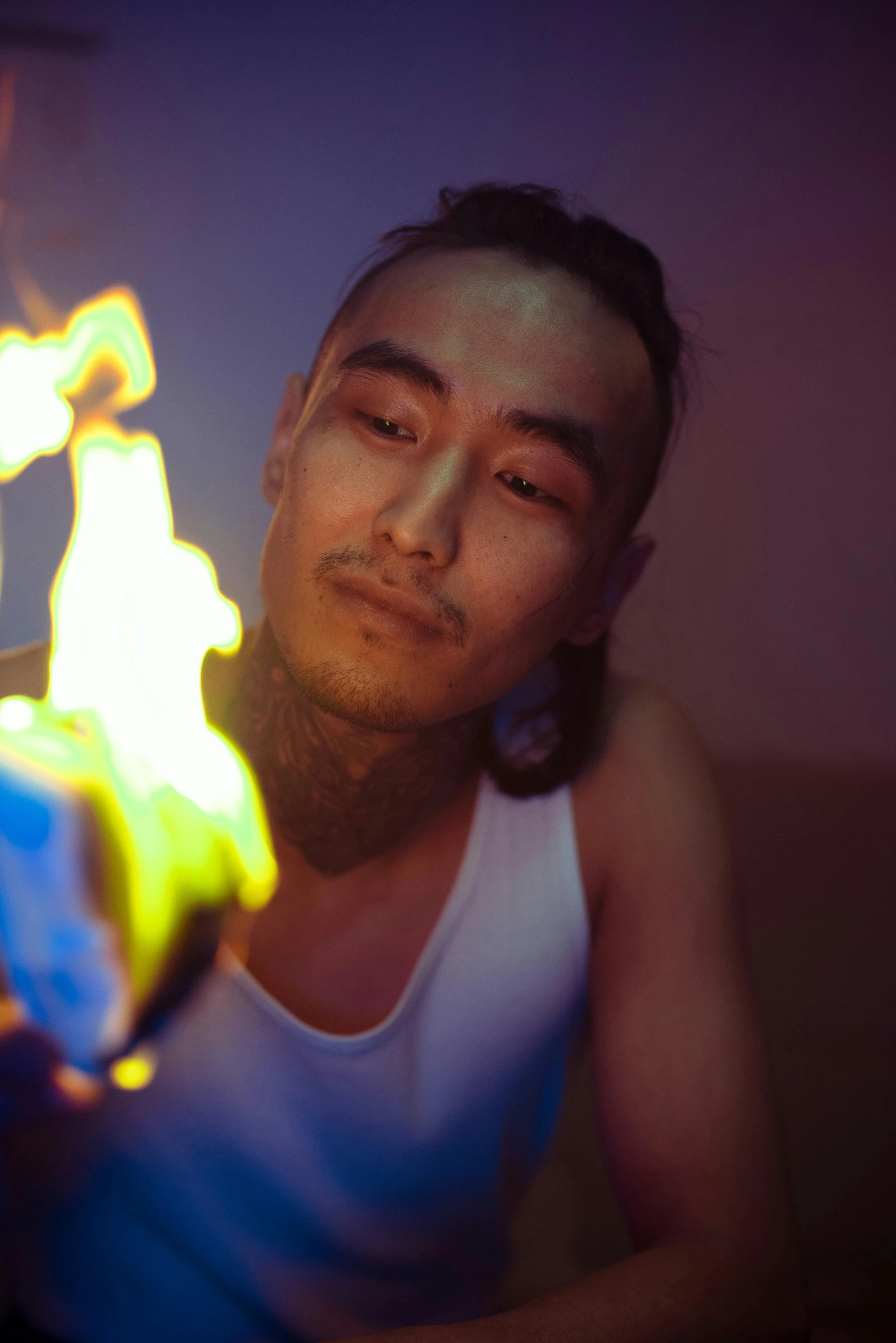 a man that is sitting down with a fire in his hand, an album cover, inspired by Fei Danxu, unsplash, bisexual lighting, headshot, mongolia, bright lights