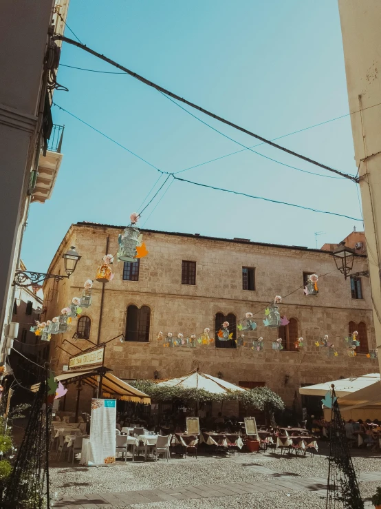 a street filled with lots of tables and umbrellas, a photo, pexels contest winner, renaissance, conversano, sunny sky, youtube thumbnail, background image