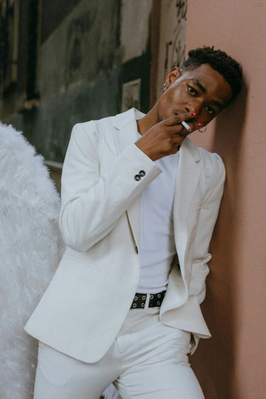 a man in a white suit smoking a cigarette, by Cosmo Alexander, trending on pexels, harlem renaissance, cai xukun, non binary model, waist high, riyahd cassiem