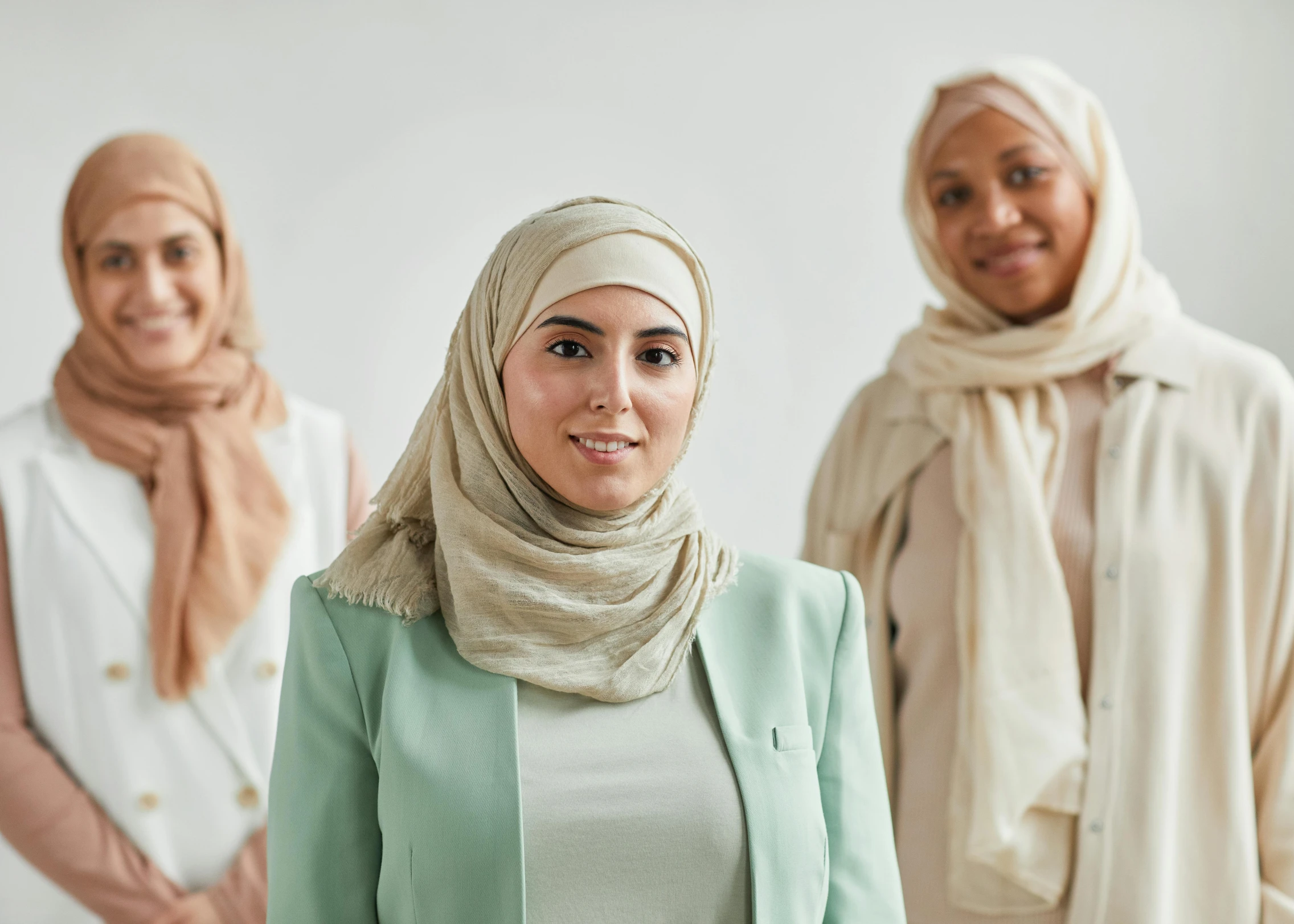 a group of women standing next to each other, hurufiyya, professional image, middle eastern skin, multiple stories, high resolution