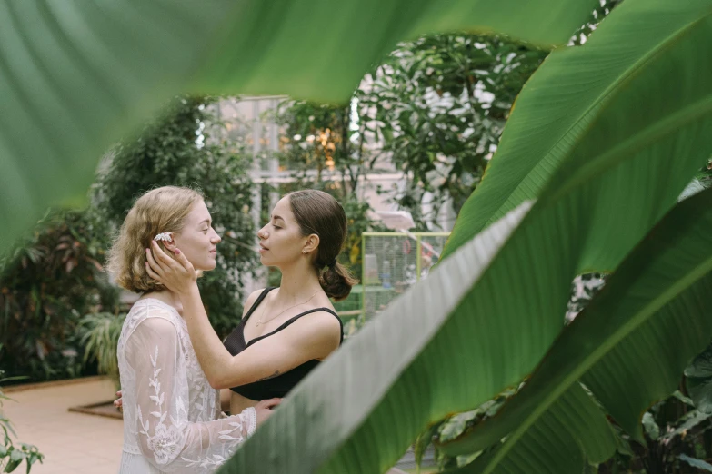 a couple of women standing next to each other, inspired by Elsa Bleda, trending on pexels, renaissance, romantic greenery, biodome, making out, wedding