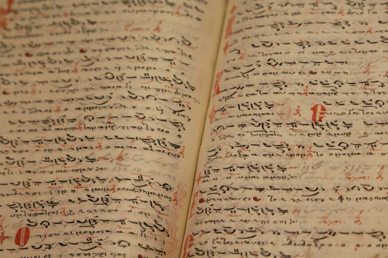 an open book with arabic writing on it, by David Simpson, pexels, mingei, tibetan text script, over-shoulder shot, panel, scientific photo