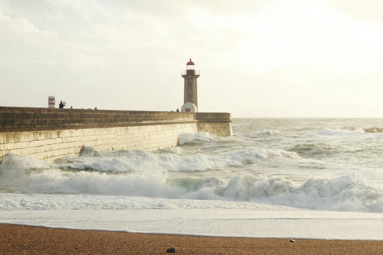 a man riding a surfboard on top of a sandy beach, by Romain brook, pexels contest winner, light house, port scene background, rough waves, port