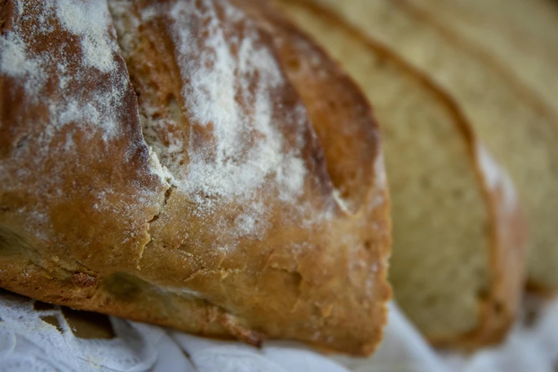 a loaf of bread sitting on top of a piece of paper, up-close, traditional corsican, fan favorite, medium close shot