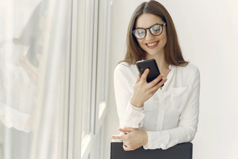 a woman in glasses holding a laptop and smiling, trending on pexels, corporate phone app icon, white, modelling, student