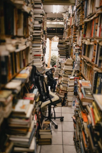 a book store filled with lots of books, a portrait, unsplash contest winner, a messy, backfacing, 💣 💥💣 💥, stacked image