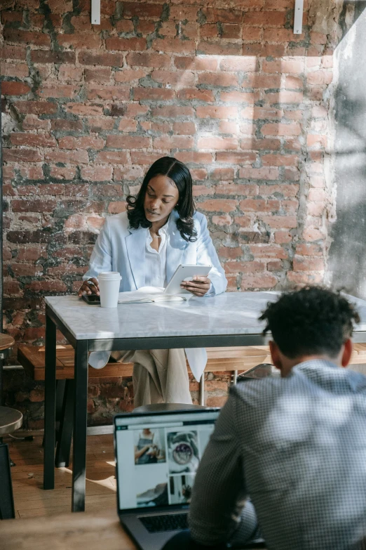 a group of people sitting around a table with laptops, pexels contest winner, african american woman, sitting on a mocha-colored table, walking down, handsome