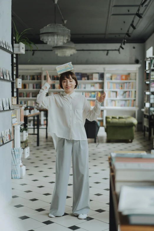 a woman that is standing in a room, inspired by Kim Jeong-hui, pexels contest winner, happening, small library, wearing a baggy, wearing white shirt, gif