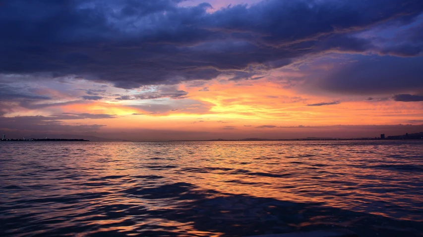 a large body of water under a cloudy sky, during a sunset, vacation photo, phot