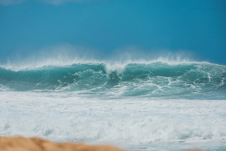 a man riding a wave on top of a surfboard, pexels contest winner, renaissance, kauai springtime, blue crashing waves, half submerged in heavy sand, aquamarine