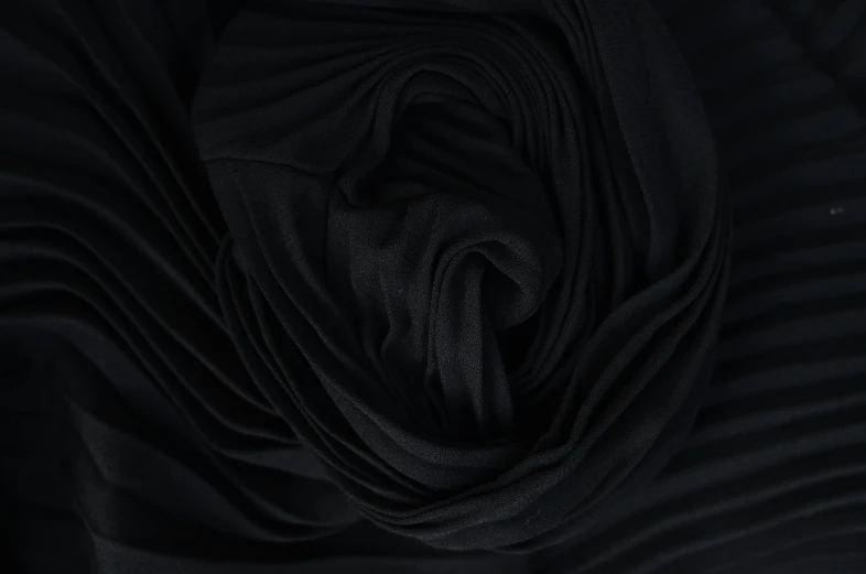 a close up shot of a black fabric, a picture, inspired by Pierre Soulages, deviantart, baroque, black rose, folds of fabric, detailed product image, bottom - view