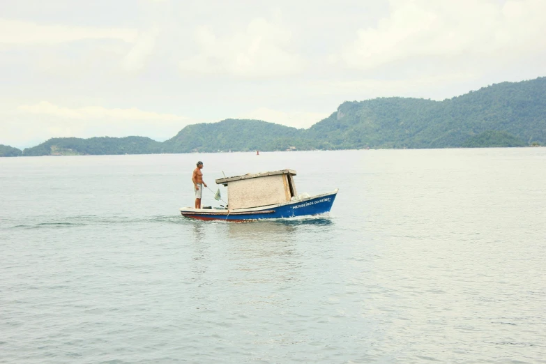 a man standing on top of a boat in the water, by Lubin Baugin, sumatraism, style of joel meyerowitz, on the coast, small boat, full body image