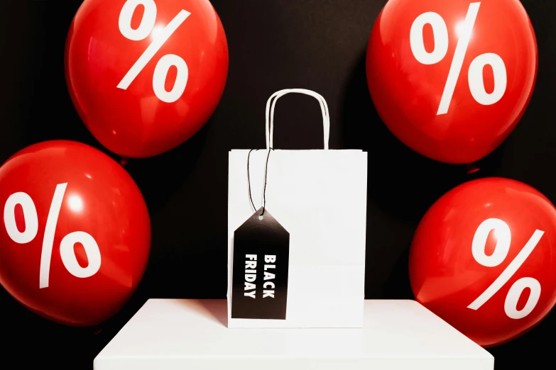 a bunch of red balloons with black friday tags on them, by Julia Pishtar, pexels contest winner, black + white, bags of money, off - white collection, taken on iphone 14 pro