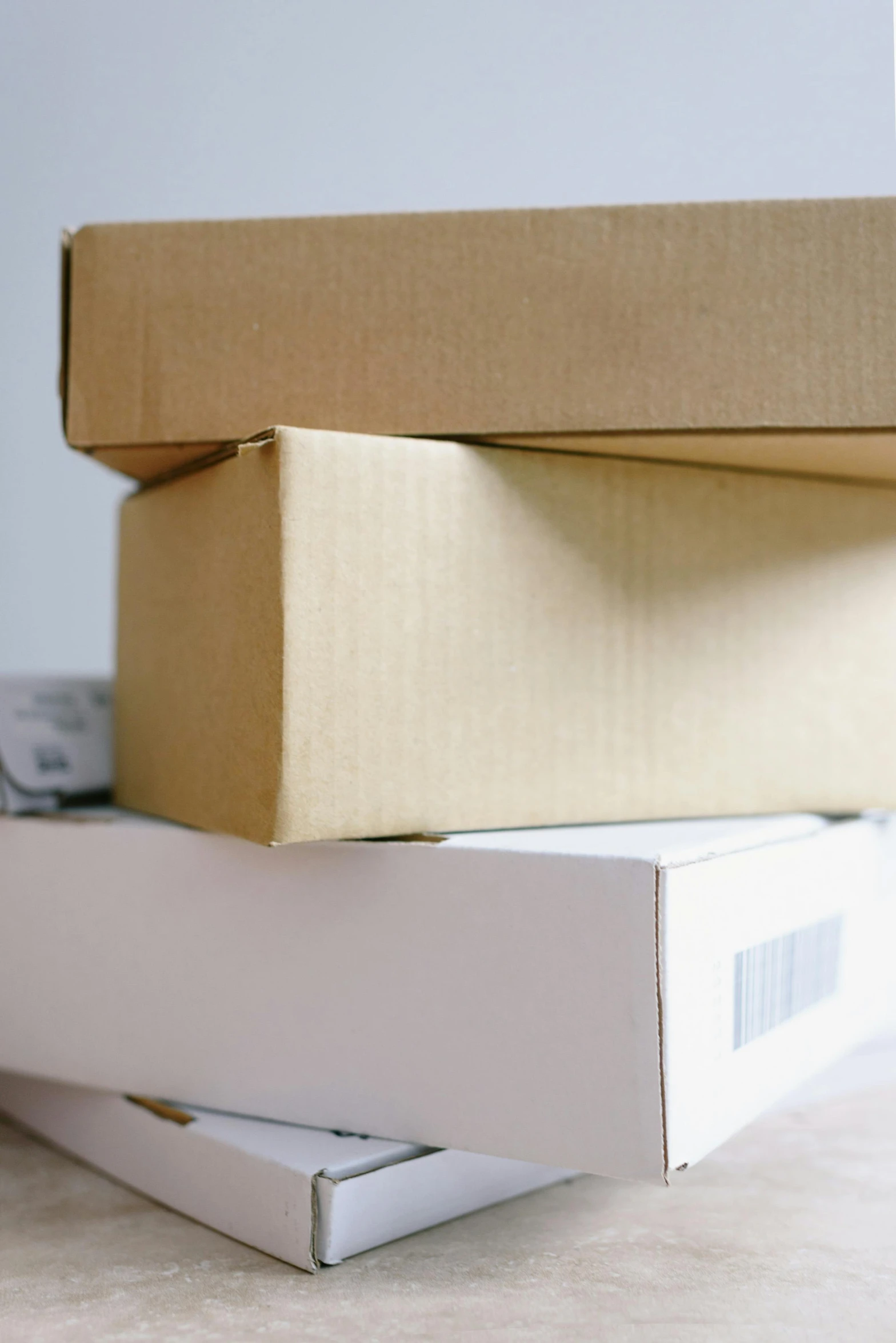 a stack of boxes sitting on top of a table, a stock photo, private press, up-close, tan, 3 pm, ecommerce photograph