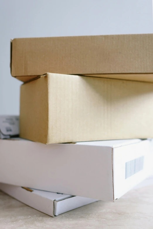 a stack of boxes sitting on top of a table, a stock photo, private press, up-close, tan, 3 pm, ecommerce photograph