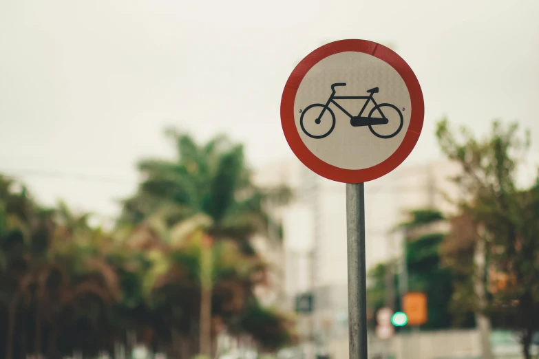 a red and white sign sitting on the side of a road, unsplash, bicycles, 9 9 designs, avenida paulista, pictogram