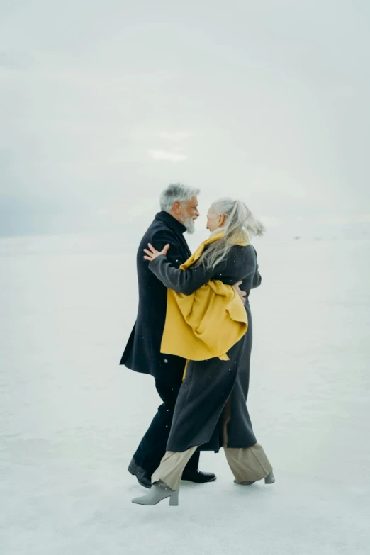 a man and a woman dancing in the snow, a colorized photo, by Jaakko Mattila, pexels contest winner, gray haired, alec soth : : love, silver and gold, reykjavik