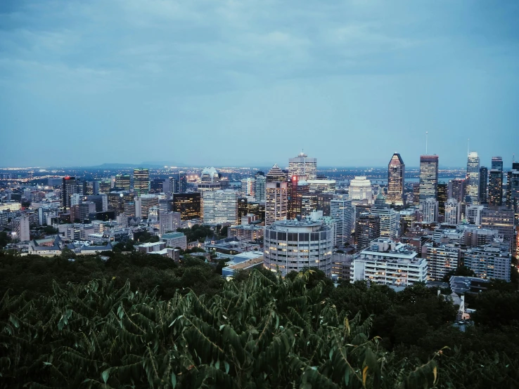 a view of a city from the top of a hill, pexels contest winner, montreal, humid evening, french, annie liebowitz