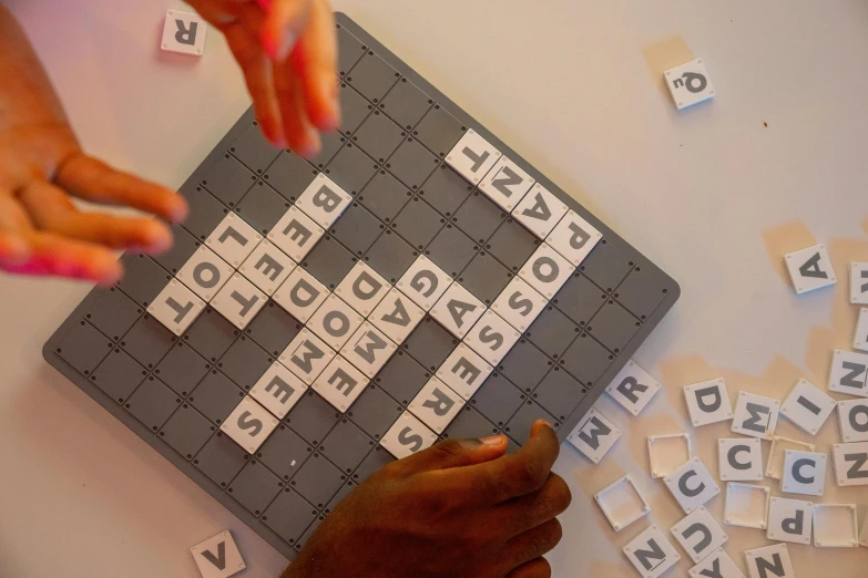 a close up of a person playing a game of scrabble, a jigsaw puzzle, by Jessie Algie, letterism, grey, square, thumbnail, families playing