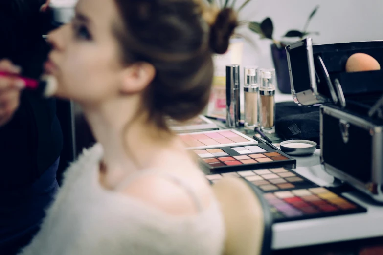 a woman is getting her make up done, by Julia Pishtar, trending on pexels, avatar image, rectangle, fancy dressing, blurred