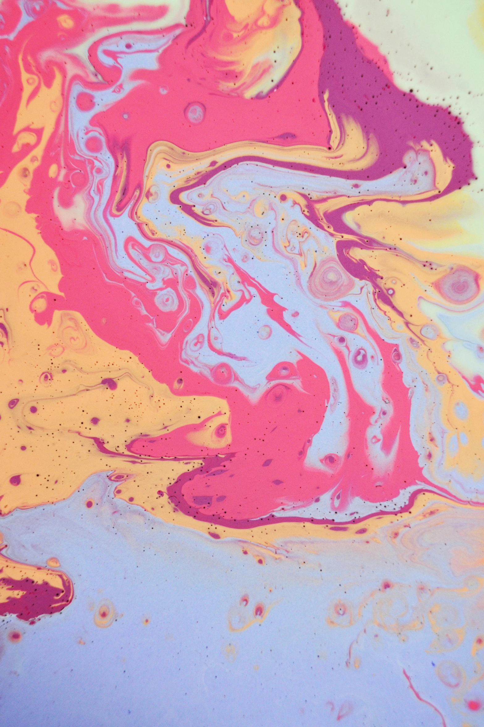 a close up of a painting on a table, trending on unsplash, abstract art, marbled swirls, pink and yellow, made of liquid, ecstasy