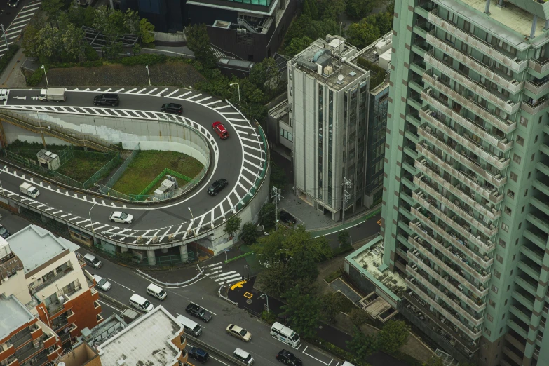 a city filled with lots of tall buildings, by Yasushi Sugiyama, unsplash, photorealism, serpentine curve!!!, helipad, arasaka, a car