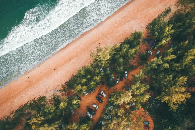 an aerial view of a beach and the ocean, pexels contest winner, camping, red sand, trees around, thumbnail