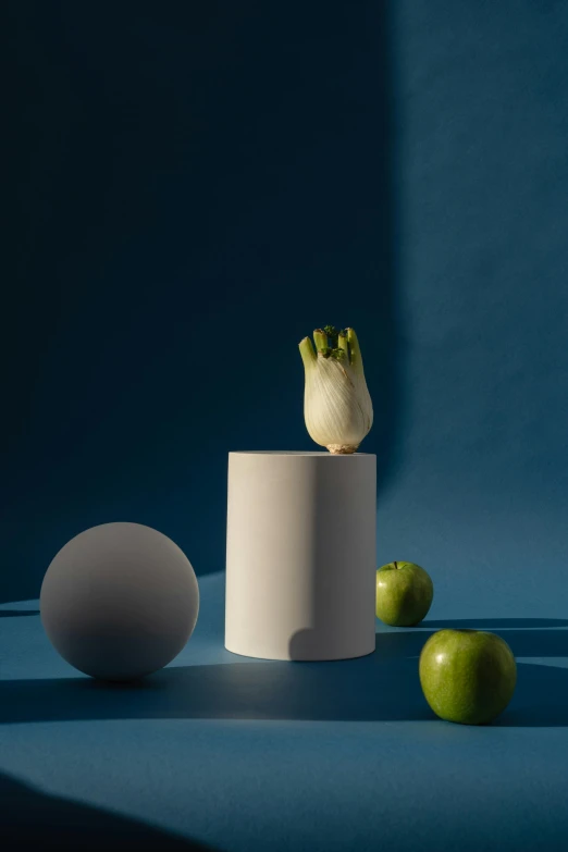 a white vase sitting on top of a table next to green apples, a still life, unsplash, conceptual art, behance lemanoosh, with blue light inside, artichoke, levitating agricultural sphere