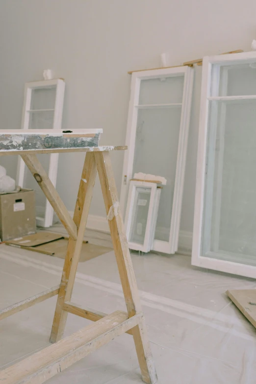 a room that has a ladder in the middle of it, a painting, unsplash, arbeitsrat für kunst, under construction, french door window, white furniture, low quality photo