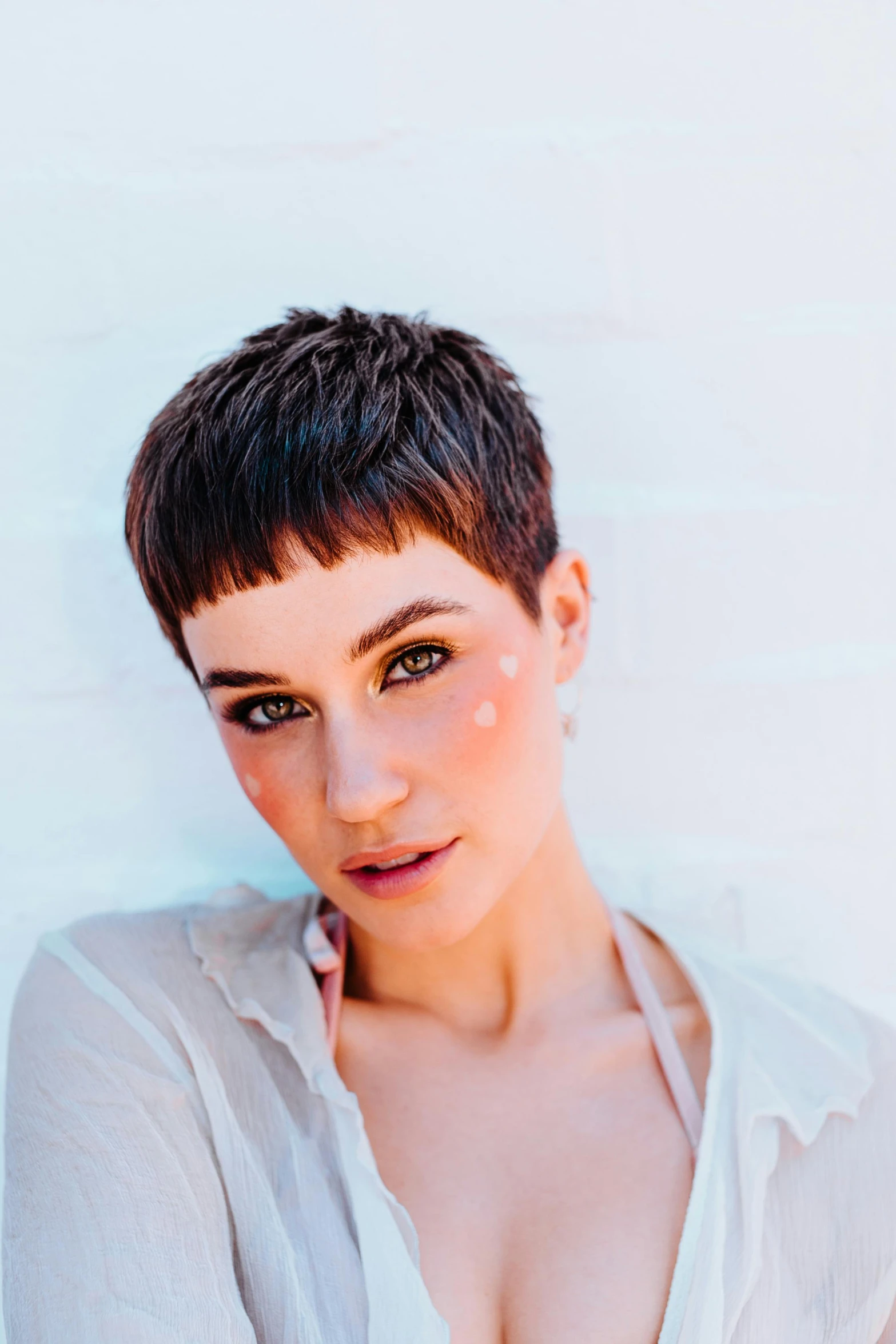 a woman in a white shirt posing for a picture, an album cover, by John Luke, trending on pexels, brown buzzcut, sasha grey, pixie haircut wlop, promotional image