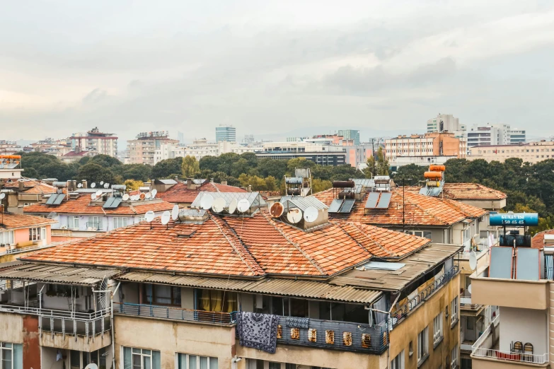 a view of a city from the top of a building, inspired by Almada Negreiros, unsplash, art nouveau, peaked wooden roofs, fintan magee, wide shot photograph, square