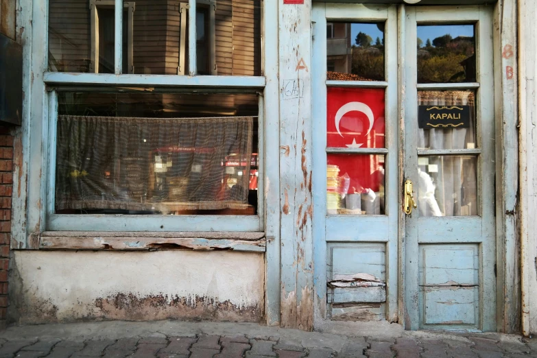 a close up of a building with a clock on it, a silk screen, by Lucia Peka, pexels contest winner, hurufiyya, shop front, turkey, brancusi, inside an old magical shop