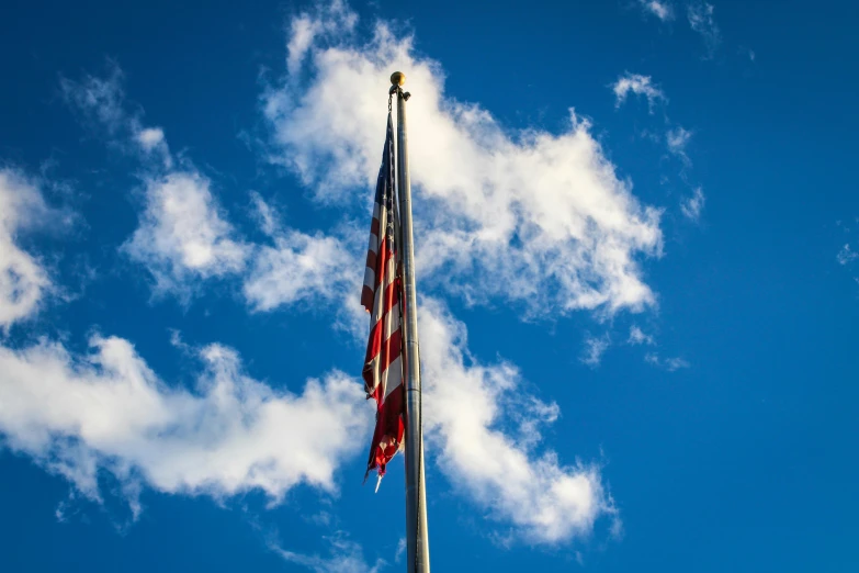 the american flag is flying high in the sky, a portrait, unsplash, hurufiyya, ceremonial clouds, shot on sony a 7, beautiful day, tall thin