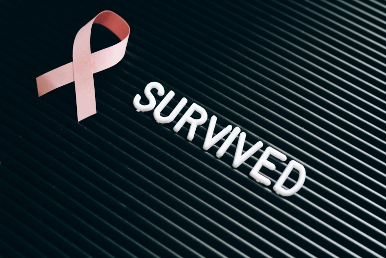 a pink ribbon with the word survived on it, happening, evenly lit, tumors, road trip, profile image