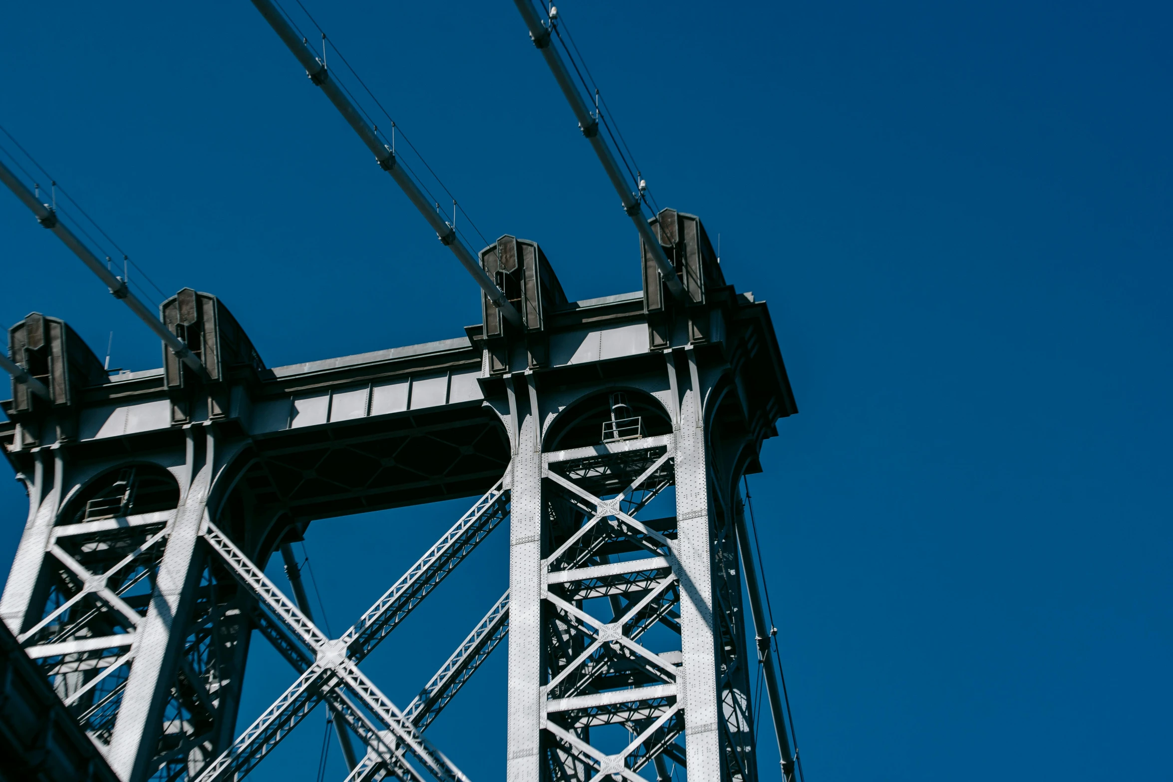 a view of the top of a bridge from below, unsplash, industrial colours, blue, brooklyn background, white mechanical details