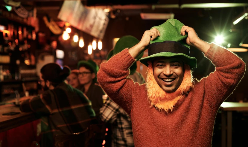 a man wearing a green hat in a bar, pexels contest winner, happening, the lorax, irish genes, happy people, thumbnail