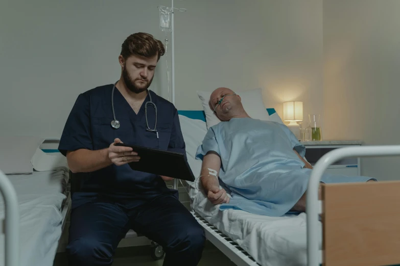 a man in a hospital bed looking at a tablet, a colorized photo, pexels contest winner, calmly conversing 8k, knees upturned, inspect in inventory image, lachlan bailey