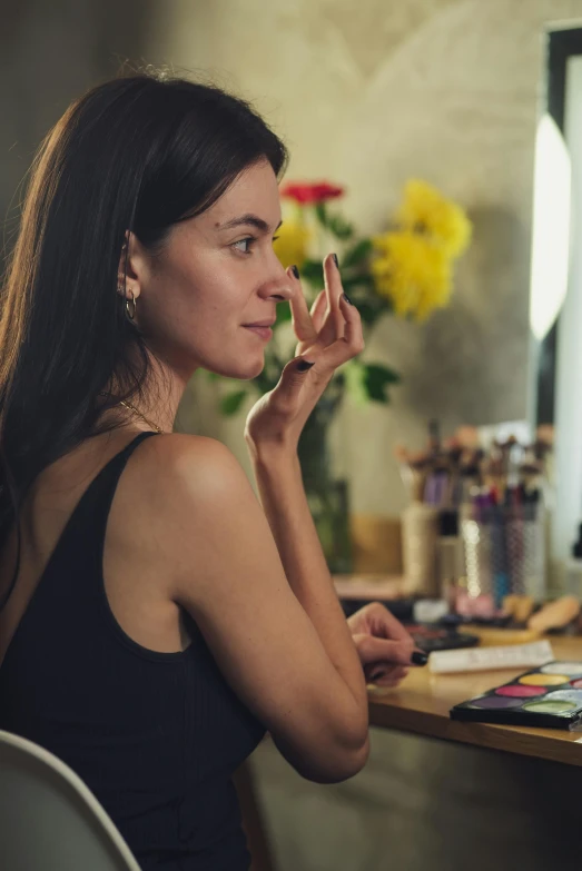 a woman sitting at a desk in front of a computer, pexels contest winner, photorealism, evening makeup, admiring her own reflection, promo image, with professional makeup